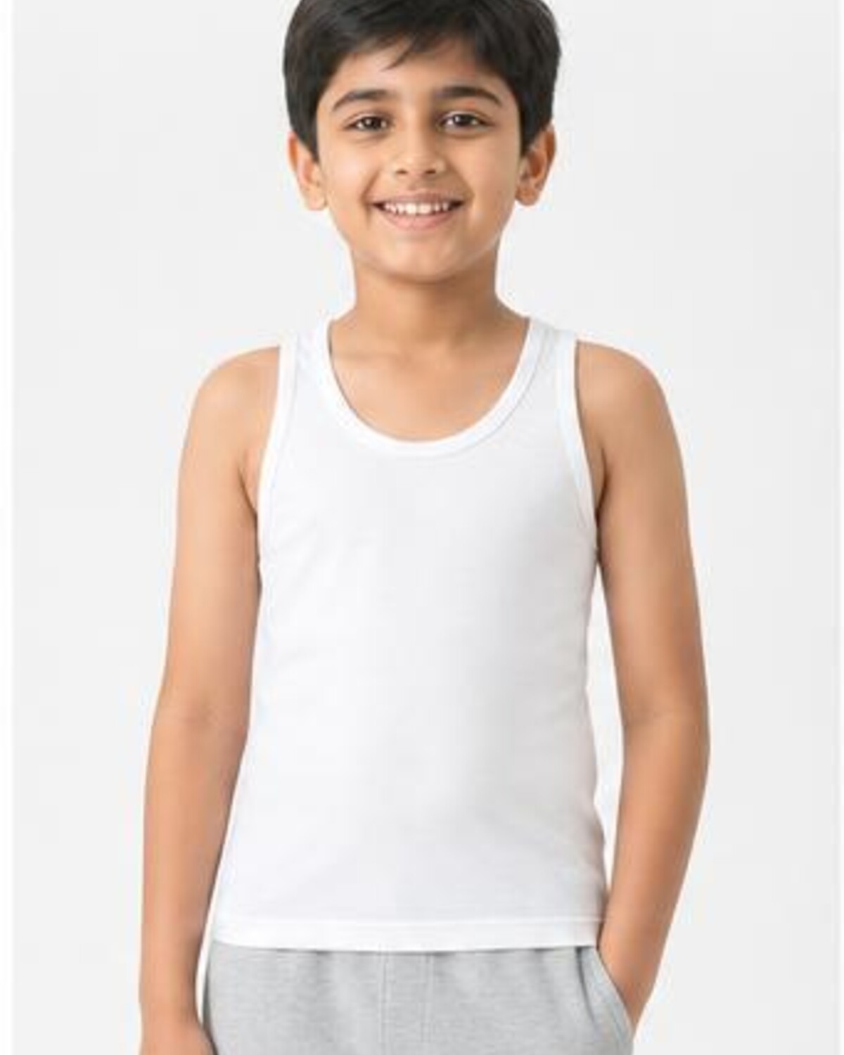 Child wearing the Kids' White Cotton Vest, showing its everyday fit